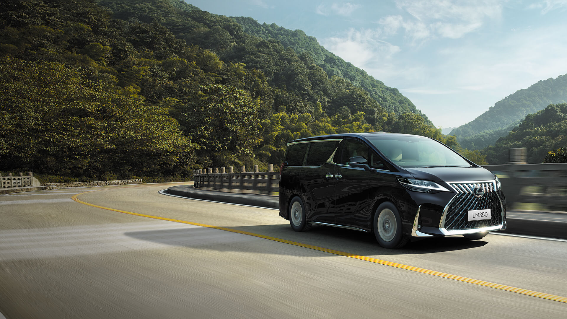 Black Lexus LM being driven on the road.