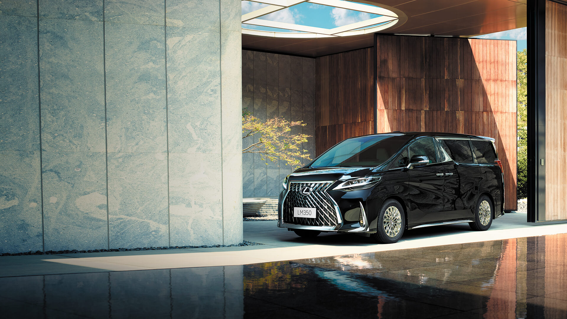 Black Lexus LM parked in an urban building.