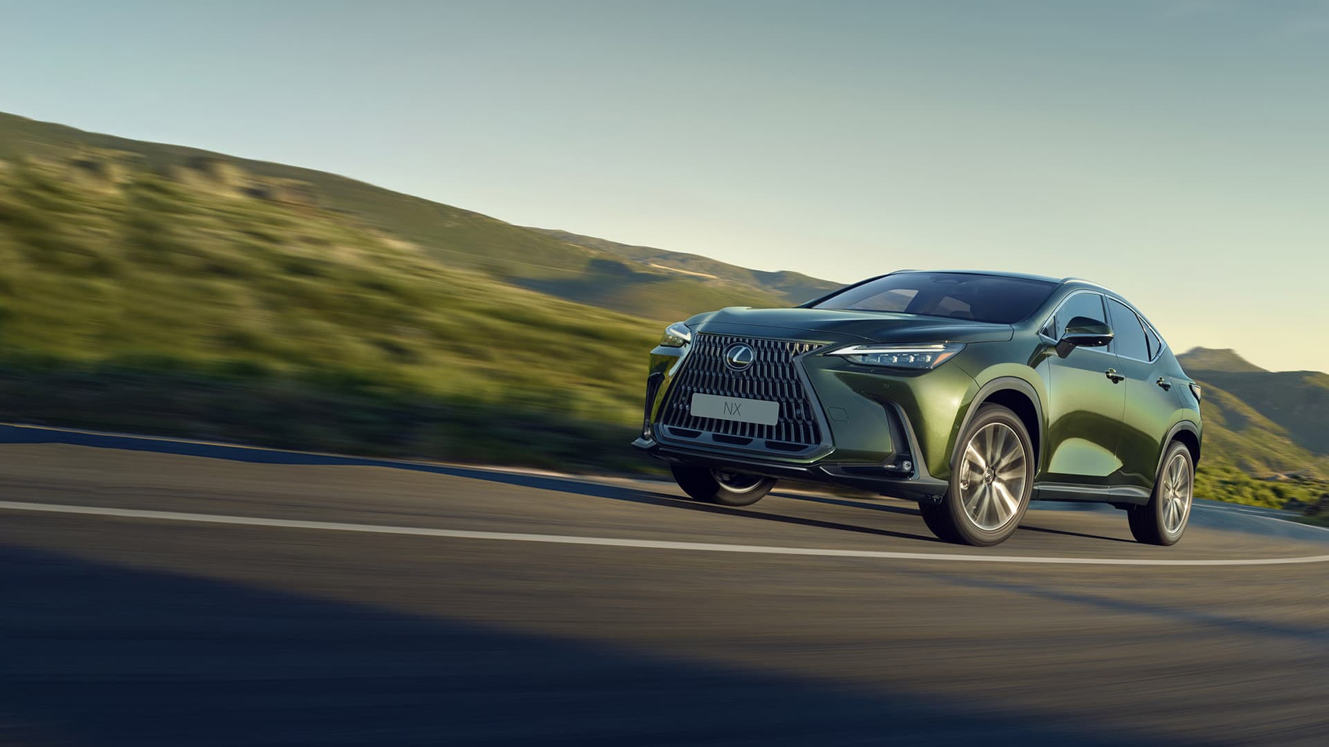 Green NX being driven on the road.