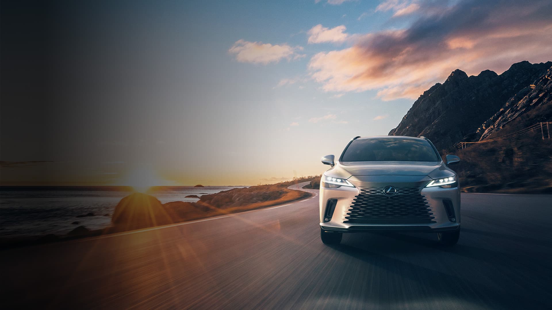 Lexus RX against scenic backdrop of sun setting