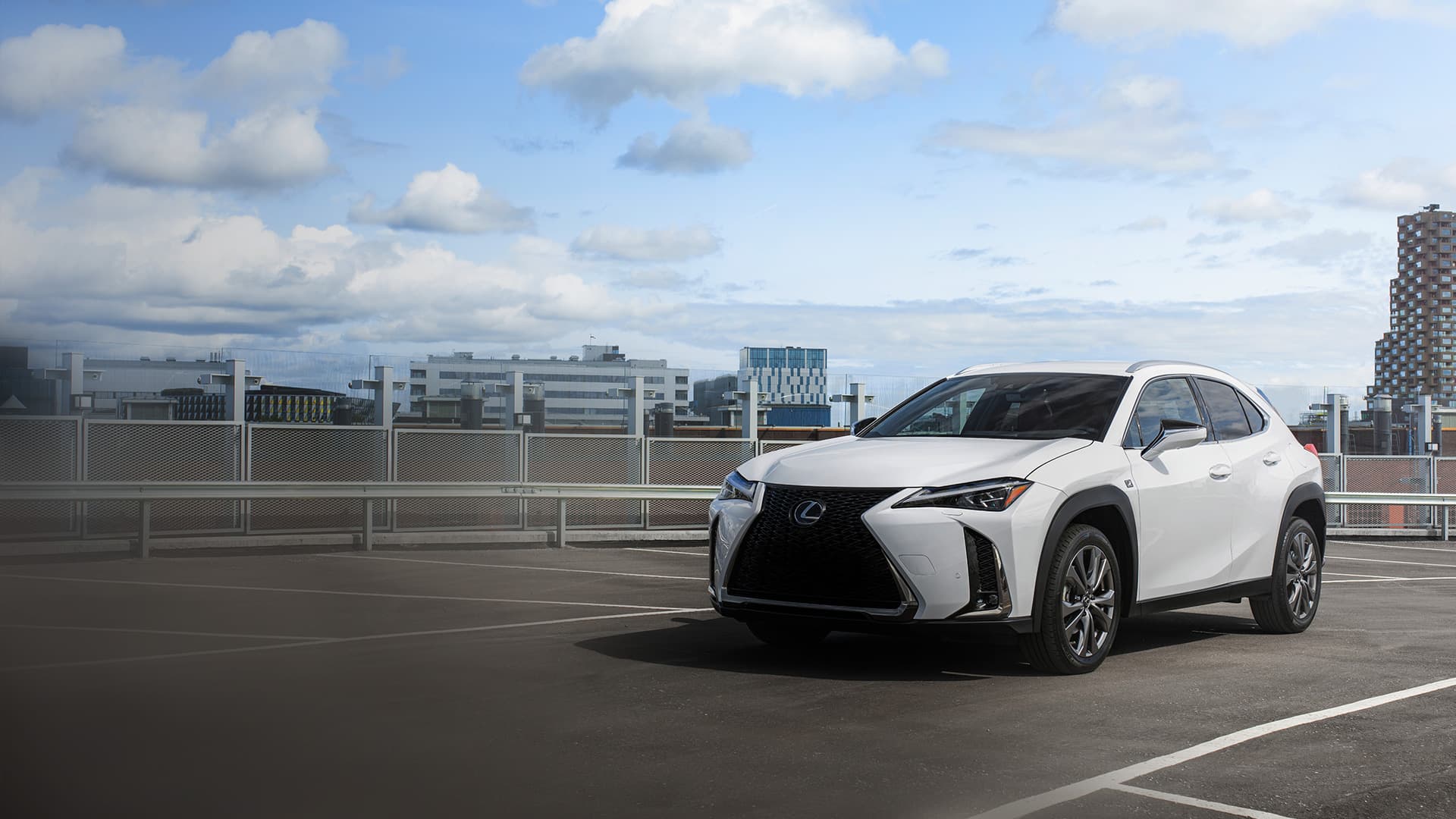White Lexus UX on a rooftop carpark.